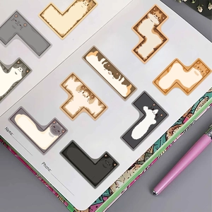 Detailed view of Tetris-shaped cat stickers on a notebook for DIY guitar decoration