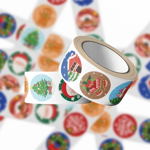 Close-up of decorative Christmas stickers roll featuring Santa and festive holiday patterns