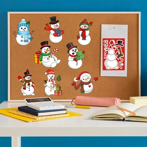 DIY Christmas snowman stickers set for kids on a cork board with festive craft supplies