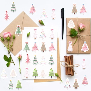 Detailed view of colorful Christmas tree stickers used for decorating envelopes and gift boxes