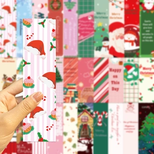 Close-up of hand holding festive Christmas bookmark with creative cartoon holiday designs