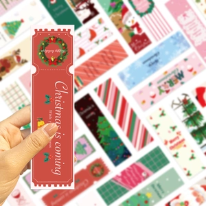 Detail of red Christmas bookmark with festive wreath illustration and thick card texture
