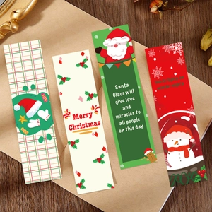 Set of four cartoon Christmas paper bookmarks with Santa and Snowman on wooden desk