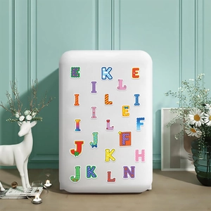 Colorful DIY cartoon letter stickers on white cabinet with stylish home decor background