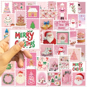 Close-up of pink Christmas stamp-style stickers with Santa, snowman and gingerbread man motifs