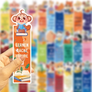 Detail of orange cartoon bookmark with reading monkey and German text Lernen macht Freude