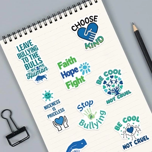 Set of 50 anti-bullying graffiti stickers with motivational slogans on a notebook