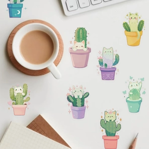 Cute cartoon cat cactus stickers set for laptop and journal decoration on a tidy desk