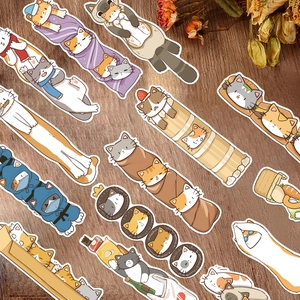Close-up of cute cartoon Japanese cat stickers on a textured wood background