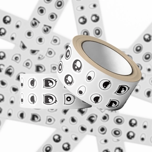 Close-up of rolling stickers with black and white cartoon anime eye patterns on tapes