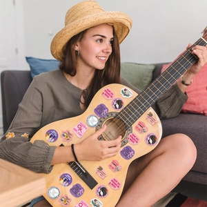 Girl Power decorative stickers roll featuring floral patterns on a wooden guitar