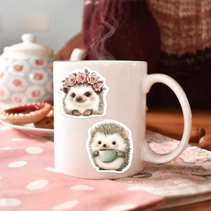 Cartoon hedgehog stickers with flower crown and coffee cup on a ceramic mug in tea setting