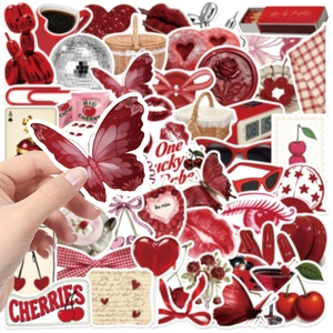 Detailed close-up of a hand holding a red Y2K cherry aesthetic sticker with glossy finish