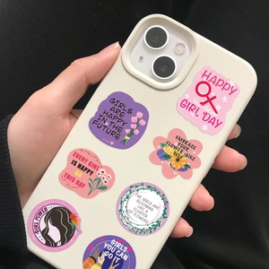 Detail of Women's Day decorative stickers on phone case featuring Girl Power quotes