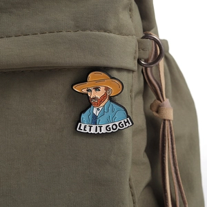 Detail of artistic Van Gogh enamel pin with 'LET IT GOGH' text on a canvas bag