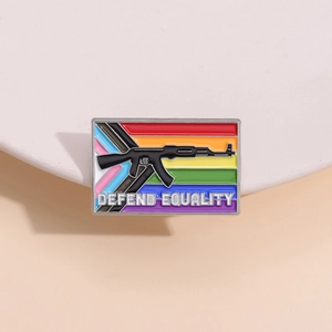 Macro view of rainbow enamel badge with rifle silhouette and Defend Equality text