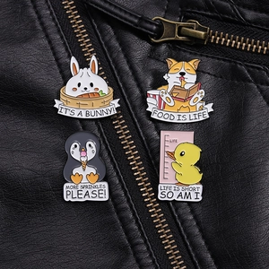 Detail of colorful enamel animal brooches on a black leather jacket featuring a cute bunny