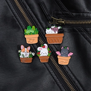 Detailed view of enamel pins with animal and cactus designs on a black leather jacket