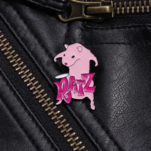 Detail of pink cartoon enamel pin with RATZ text on a black leather jacket texture