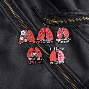Detail of five medical lung enamel pins on black leather jacket with medical slogans