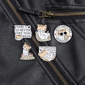 Detail of five cartoon enamel cat pins attached to a stylish black leather jacket