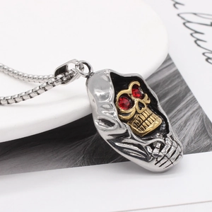 Pendentif faucheuse gothique avec crâne doré et yeux rouges sur chaîne en acier
