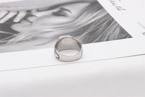 Detail view of wide stainless steel vintage skull ring band with dark side engravings