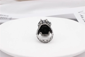Macro detail of gothic skull ring with vintage oxidized finish on white pedestal