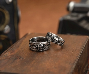Macro shot of vintage skull rings with thunderbolt patterns and engraved internal date