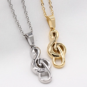 Minimalist musical treble clef pendant necklaces in polished gold and silver steel finish