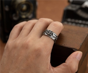 Detailed close-up of a vintage skull ring with intricate lightning engravings on the band