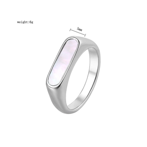 Macro shot of silver ring with white shell inlay, showing 5mm width and 6g weight