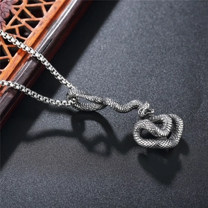 Vintage oxidized stainless steel snake pendant with textured scales on a black box chain