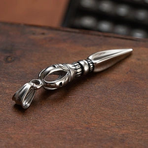 Retro stainless steel Buddhist vajra pestle necklace pendant on vintage wood background