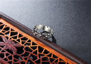 Detailed macro view of vintage stainless steel feather ring with oxidized textures