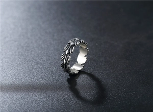 Macro detail of retro silver feather ring showing vintage oxidized metal textures