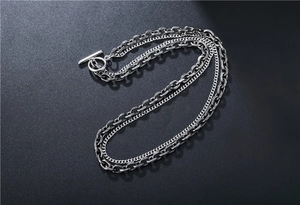 Close-up of double-layer vintage silver chain necklace featuring a classic OT toggle clasp