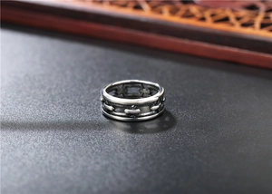Macro detail of retro punk silver ring with embossed chain texture on leather surface