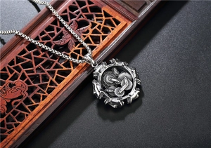 Macro detail of vintage steampunk gear pendant on a textured box chain necklace