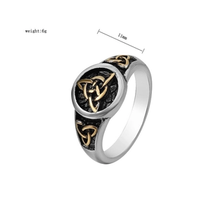 Detail of vintage Viking Celtic knot ring with gold triquetra relief and oxidized texture