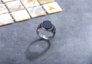 Detail of vintage Viking signet ring with black gemstone and Celtic knots pattern