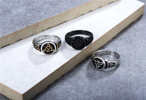 Macro shot of Viking Celtic knot rings in silver, gold, and black stainless steel finishes