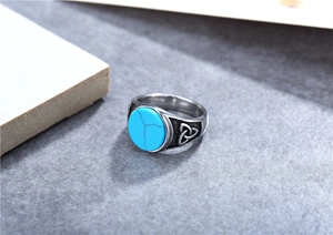 Detail of vintage signet ring featuring turquoise stone and Celtic knot engraving