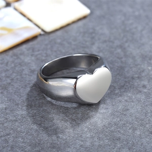 Minimalist silver stainless steel wide ring featuring a white enamel heart on a textured background