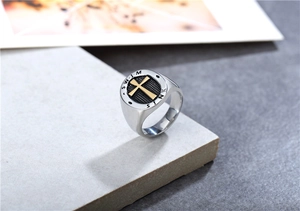 Detailed macro view of retro punk signet ring with golden cross on black grid