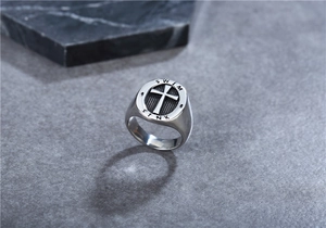 Detail of vintage silver punk cross signet ring with Swim and Sink engravings