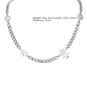 Detail of silver titanium steel Cuban chain with smile and frown face metal pendants