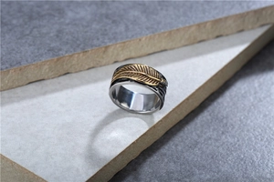 Detailed close-up of a retro punk titanium steel ring featuring a golden leaf design