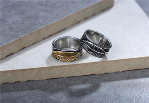Macro detail of retro feather rings with vintage silver and gold bi-color finishes