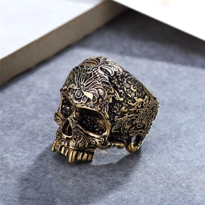 Retro punk skull ring in vintage gold finish with intricate engraved scroll patterns